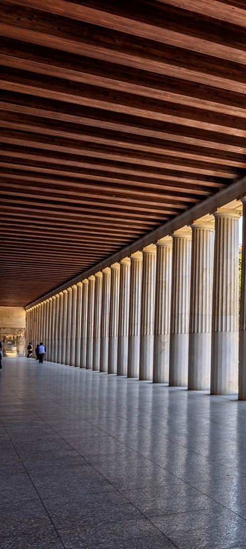 Perspective of classical building columns in ancient Agora, Athens, Greece. Panoramic view inside the Stoa of Attalos, landmark of Athens. Historical architecture of Athens city. Repetition concept.